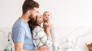 Happy parents having fun with their little baby.